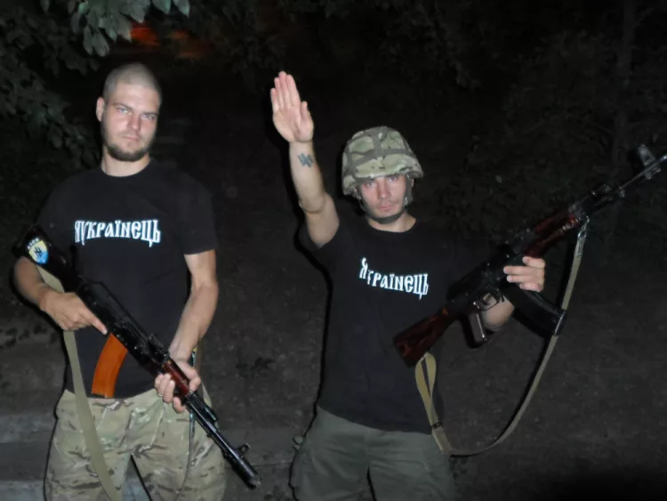 Two Azov fighters throwing a Nazi salute